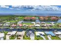 Aerial view of a waterfront neighborhood featuring lush landscaping, canal access, and stunning water views at 2815 Coral Way, Punta Gorda, FL 33950