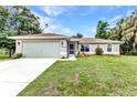 Well-maintained single-Gathering home with a manicured lawn, two-car garage, and inviting curb appeal at 3305 Nansen Ln, North Port, FL 34286