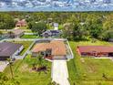 Expansive aerial view of the property showcases lush landscaping, fenced yard, sparkling pool, and well-maintained exterior at 4038 Corydon Ave, North Port, FL 34286