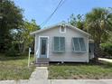Inviting single-story home with a front entrance featuring charming teal shutters at 420 W Olympia Ave, Punta Gorda, FL 33950