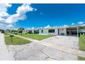 Attractive home featuring a covered parking area and a well-manicured lawn, exuding suburban charm at 720 Dalton Blvd, Port Charlotte, FL 33952
