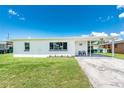 Charming single-story home with a well-maintained lawn and covered front porch, perfect for relaxing outdoors at 720 Dalton Blvd, Port Charlotte, FL 33952