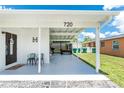 Inviting front porch with seating and covered parking, enhancing the home's functionality and appeal at 720 Dalton Blvd, Port Charlotte, FL 33952
