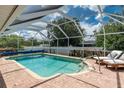 Enclosed pool with lounge seating and landscaped surroundings, creating a private oasis at 976 Great Falls Nw Ter, Port Charlotte, FL 33948