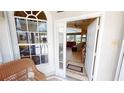 Open front door provides views to the foyer and living room with tile floors and high ceilings at 10214 Arrowhead Dr, Punta Gorda, FL 33955