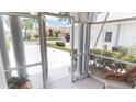 View from tiled screened porch to the homes across the street, showcasing the community at 10214 Arrowhead Dr, Punta Gorda, FL 33955