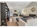 Inviting living room with a comfortable gray sofa, stylish decor, hardwood floors, and natural light at 1053 Yarmouth St, Port Charlotte, FL 33952
