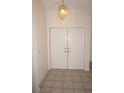 Foyer with tile floors and double-door closet at 1128 Rum Cay Ct, Punta Gorda, FL 33950