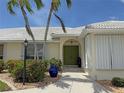 Inviting home entrance featuring double front doors, stone pathway, and attractive landscaping at 1128 Rum Cay Ct, Punta Gorda, FL 33950