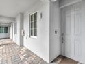 Apartment exterior with hallway featuring a door, window, and exterior lighting fixture at 14081 Heritage Landing Blvd # 214, Punta Gorda, FL 33955