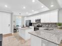 Open kitchen featuring granite countertops, stainless steel appliances, and a view to a seating area at 14081 Heritage Landing Blvd # 214, Punta Gorda, FL 33955