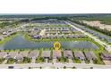Aerial view of homes in the community overlooking a pond with easy access to amenities at 16848 Canopy Garden Dr, Port Charlotte, FL 33953