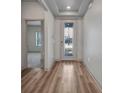 Bright foyer with decorative front door, sidelights, and hardwood flooring at 16848 Canopy Garden Dr, Port Charlotte, FL 33953