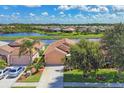 Aerial view showcasing the home's prime location near a scenic lake within a residential community at 1775 Scarlett Ave, North Port, FL 34289