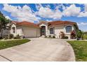 Home with a tile roof, attached garage, and a curved driveway leading to the entrance at 2105 Deborah Dr, Punta Gorda, FL 33950