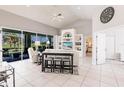 Living room featuring tile floors, built-in shelving, and sliding glass doors to the lanai at 2105 Deborah Dr, Punta Gorda, FL 33950