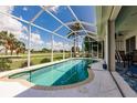 Screened-in pool and lanai area with outdoor furniture, providing a private and relaxing space at 2105 Deborah Dr, Punta Gorda, FL 33950