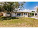 Inviting single-Gathering home with a tidy lawn, carport, and a mature shade tree on the property at 214 W Grace St, Punta Gorda, FL 33950