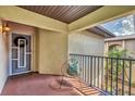 Cozy covered balcony with a chair, offering a private outdoor space with views of the lush surrounding landscape at 23465 Harborview Rd # 214, Punta Gorda, FL 33980