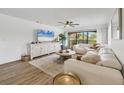 Bright and inviting living room featuring stylish decor, a large window, and comfortable seating at 23465 Harborview Rd # 214, Punta Gorda, FL 33980