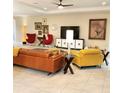 Comfortable living room with bright furnishings, a ceiling fan and artistic decor, creating a cozy atmosphere at 25224 Lahore Ln, Punta Gorda, FL 33983