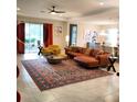 Spacious living room with stylish leather furnishings and large windows, offering a bright and comfortable space at 25224 Lahore Ln, Punta Gorda, FL 33983