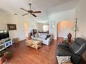 Bright living room featuring hardwood floors, a ceiling fan, and comfortable seating at 2526 Brazilia Ct, Punta Gorda, FL 33950
