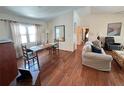 Open-concept living and dining area with hardwood floors and lots of windows at 2526 Brazilia Ct, Punta Gorda, FL 33950