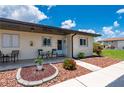 Charming condo exterior featuring a cozy porch area and well-maintained landscaping at 25275 Rampart Blvd # 404, Punta Gorda, FL 33983