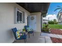 Inviting front porch with seating, a decorative wreath, and charming curb appeal at 25275 Rampart Blvd # 404, Punta Gorda, FL 33983