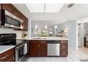 Modern kitchen features stainless steel appliances, granite countertops, and ample cabinet space at 25275 Rampart Blvd # 404, Punta Gorda, FL 33983