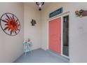 Inviting front porch with colorful decor, a decorative sun, and a cozy welcome at 26254 Stillwater Cir, Punta Gorda, FL 33955