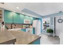 The turquoise kitchen offers modern appliances, ample counter space, and backyard views at 26310 Rampart Blvd # 504, Punta Gorda, FL 33983