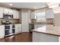 Bright kitchen featuring granite counters, stainless steel appliances, and ample cabinet space at 2736 Suncoast Lakes Blvd, Punta Gorda, FL 33980