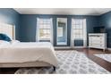 Spacious main bedroom featuring dark blue walls, hardwood floors, and bright natural light at 2736 Suncoast Lakes Blvd, Punta Gorda, FL 33980