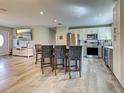 Modern kitchen with stainless steel appliances, island with seating, and open layout at 3512 Nekoosa St, North Port, FL 34287