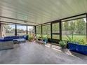 Spacious screened-in patio featuring comfortable seating and an array of potted plants at 3512 Nekoosa St, North Port, FL 34287