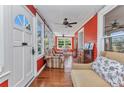 Bright sunroom featuring hardwood floors, multiple windows, and a seating area with a dining set at 415 W Marion Ave, Punta Gorda, FL 33950