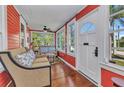 Cozy sunroom with hardwood floors, large windows, and comfortable seating area at 415 W Marion Ave, Punta Gorda, FL 33950
