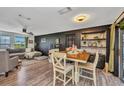 Dining area showcases a wooden table with seating, complemented by stylish decor and an open floor plan at 457 Glenridge Nw Ave, Port Charlotte, FL 33952