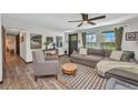 Comfortable living room featuring stylish furniture, a ceiling fan, and natural light from the windows at 457 Glenridge Nw Ave, Port Charlotte, FL 33952