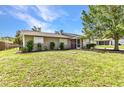Charming single-story home featuring well-kept landscaping and a cozy, inviting facade under a bright blue sky at 496 Fletcher St, Port Charlotte, FL 33954