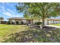 Charming single-story home featuring well-kept landscaping and a cozy, inviting facade under a bright blue sky at 496 Fletcher St, Port Charlotte, FL 33954