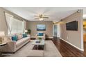 Bright living room featuring neutral tones, modern decor, and sleek hardwood floors at 496 Fletcher St, Port Charlotte, FL 33954