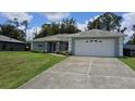 Charming single-story home featuring an attached two-car garage and a well-manicured lawn at 6341 Opa Locka Ln, North Port, FL 34291