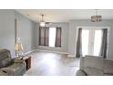 Bright living room featuring neutral paint, ceiling fan, wood-look flooring and comfortable seating at 6341 Opa Locka Ln, North Port, FL 34291
