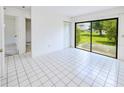 Open bedroom featuring sliding glass doors with outdoor views and tile floor at 6540 Kenwood Dr, North Port, FL 34287