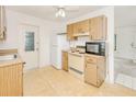 Functional kitchen featuring wooden cabinets and standard appliances at 6540 Kenwood Dr, North Port, FL 34287