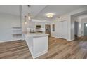 A bright kitchen featuring white cabinets, stainless steel appliances and wood floors at 900 E Marion Ave # 1203, Punta Gorda, FL 33950