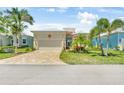 Attractive single-story home with a well-kept lawn and brick driveway in a residential neighborhood at 10478 Coquina Ct, Placida, FL 33946